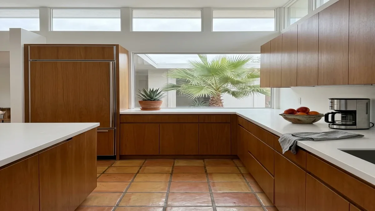 Modern Grayhawk kitchen with a panel-ready built-in Sub-Zero refrigerator and tile floor in daylight